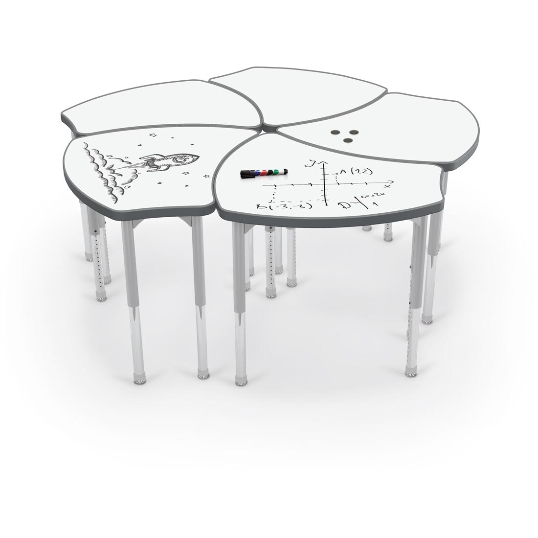 cluster of 5 MooreCo Hierarchy Shapes Desks With Porcelain Steel Tops; a marker, 3 round magnets and a dry-erase drawing are on the tops