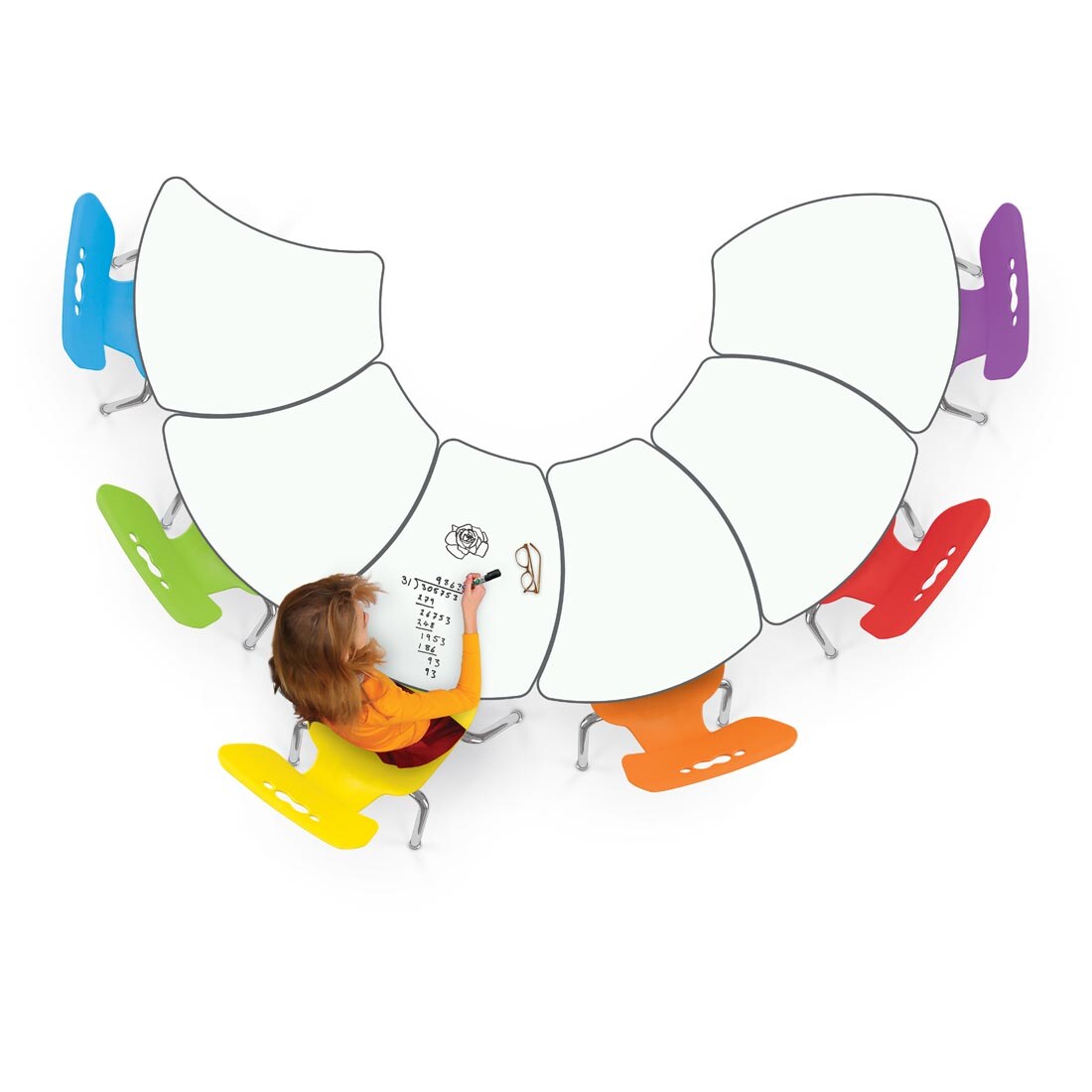 person sitting at a cluster of 6 MooreCo Hierarchy Shapes Desks With Porcelain Steel Tops surrounded by rainbow chairs, drawing on the top with a dry-erase marker