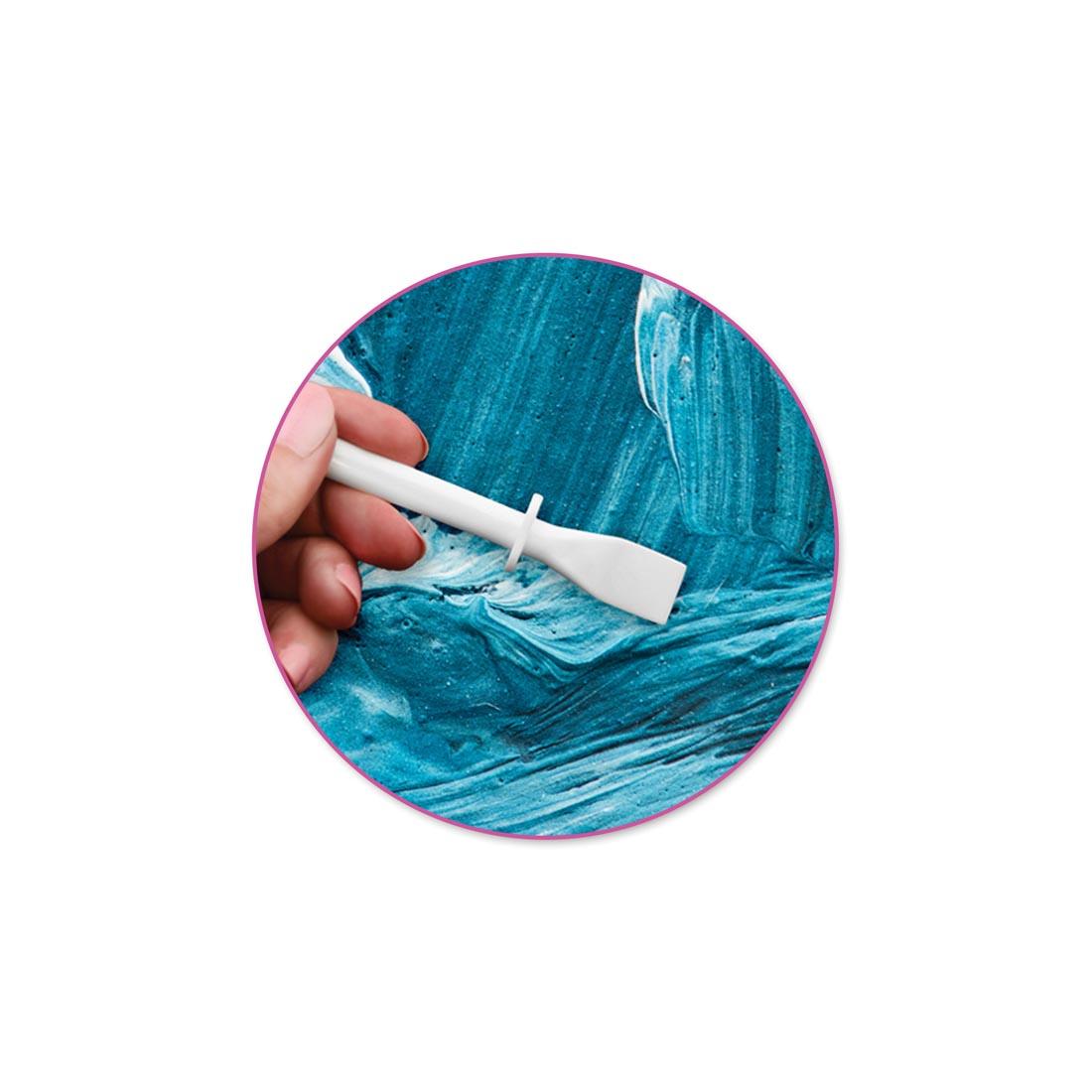 hand using a Glue & Paint Spreader