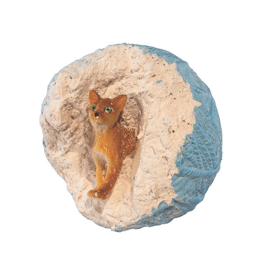cat figurine partially dug out of a piece from the Dig It Up! Discoveries Cats By Mindware