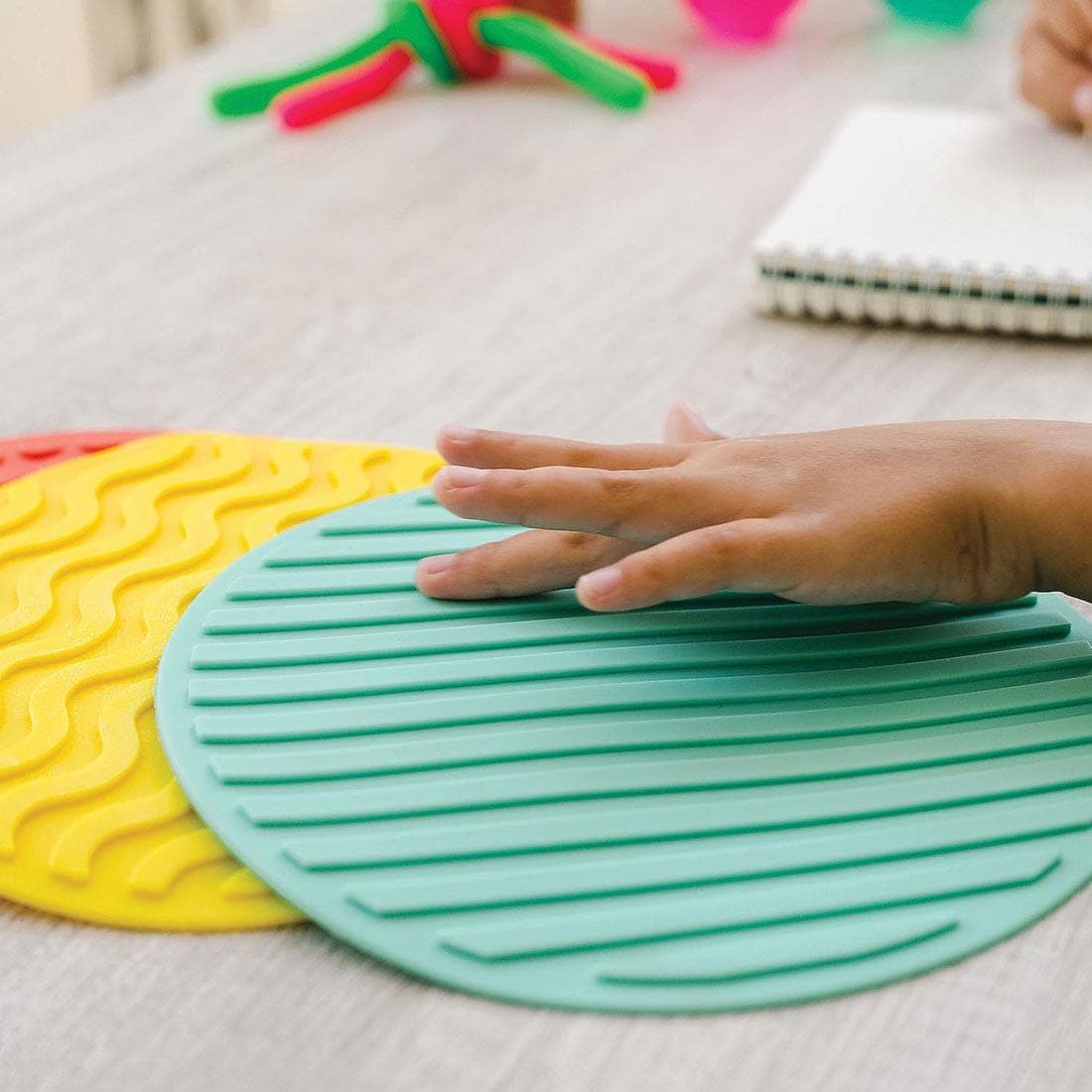 hand touching the Sensory Genius Sensory Mats By Mindware