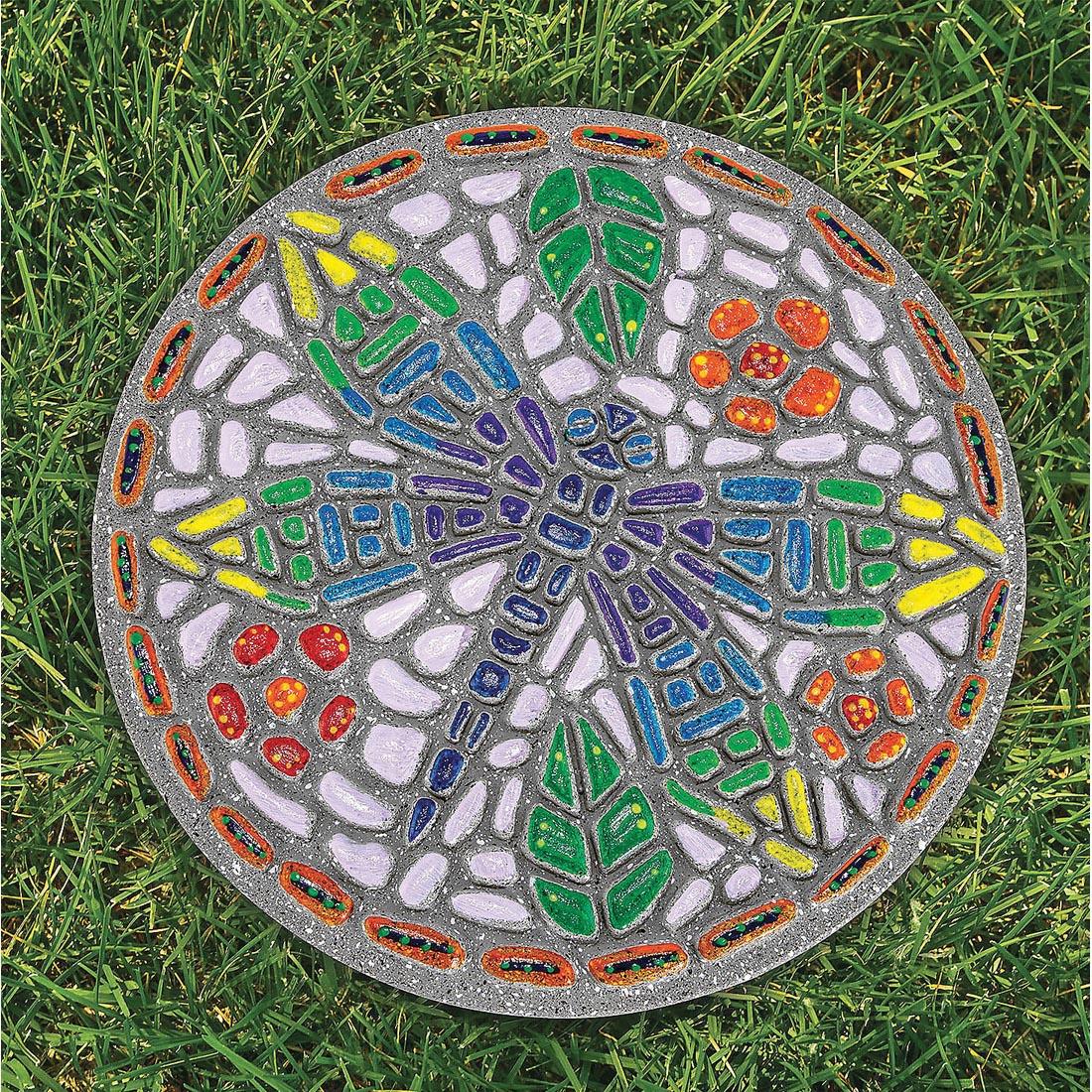 completed example of Paint Your Own Dragonfly Stepping Stone lying on grass