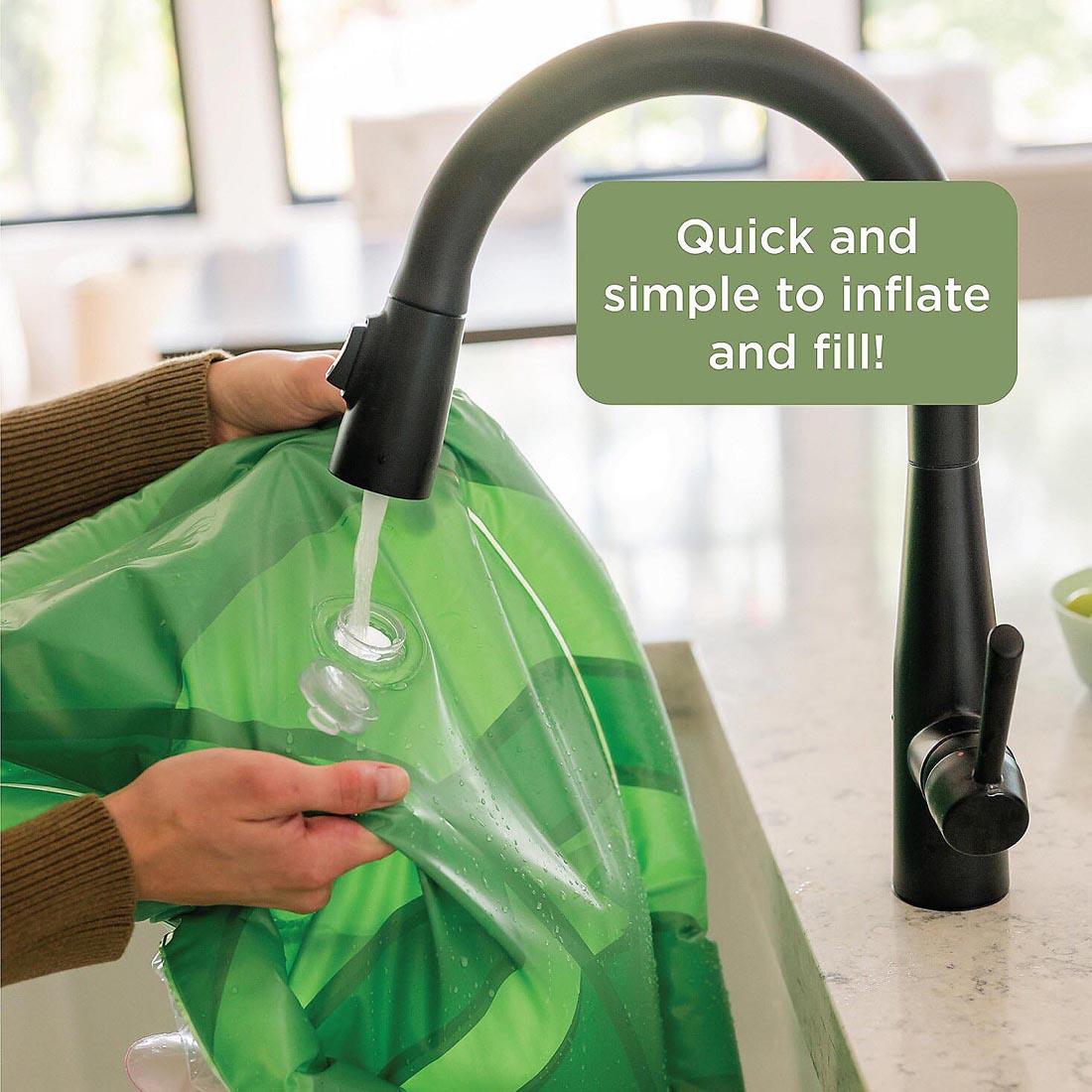 hands holding the Sensory Sprouts Baby Water Mat up to a faucet with text Quick and simple to inflate and fill!