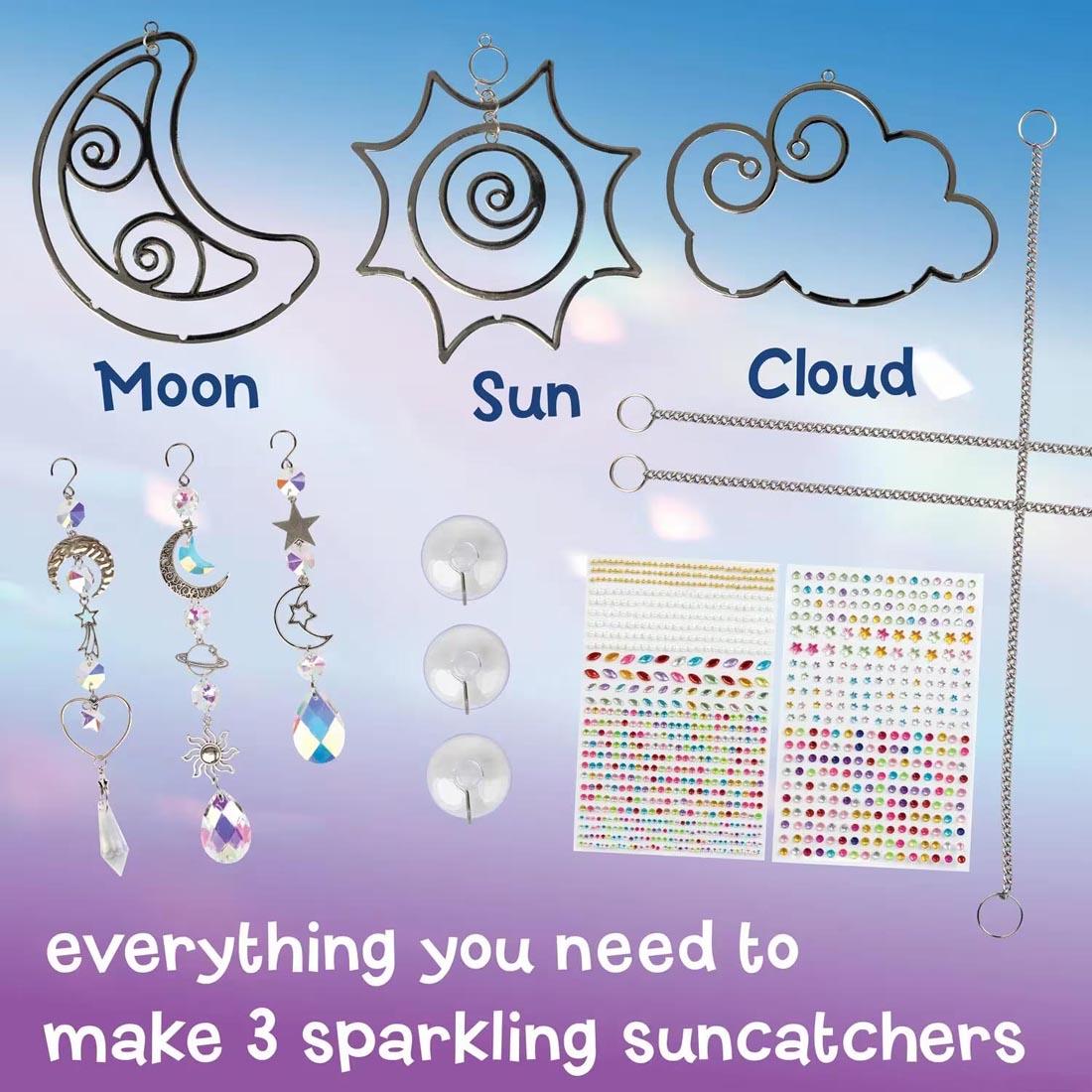 components of the Make Your Own Suncatcher Kit By Mindware labeled Moon, Sun, Cloud, plus text everything you need to make 3 sparkling suncatchers