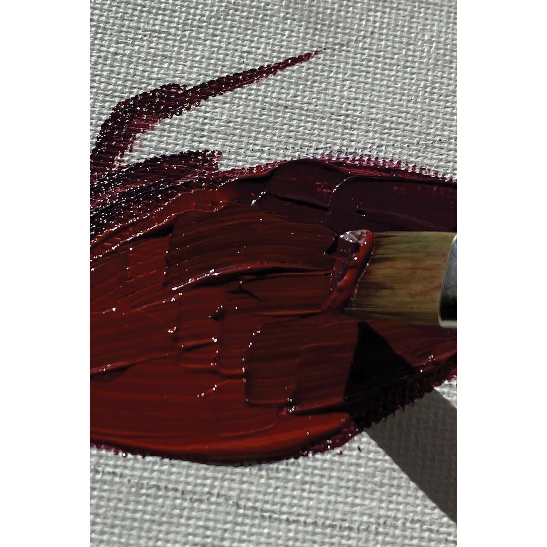 Dark crimson paint on canvas, after being mixed with Grumbacher Res-N-Gel Quick Drying Extender Gel to show texture and brush marks, with a brush tip applying the paint