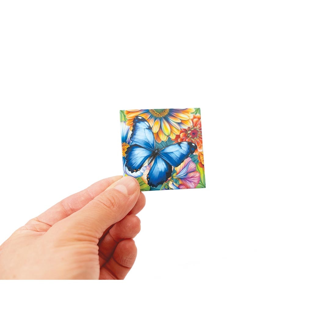 hand holding up a piece from the Butterflies 36-Piece Magic Square Tile Puzzle