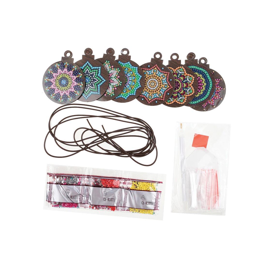 completed examples and other components of the Crystal Art Mandala Mayhem Wooden Hanging Decoration Kit
