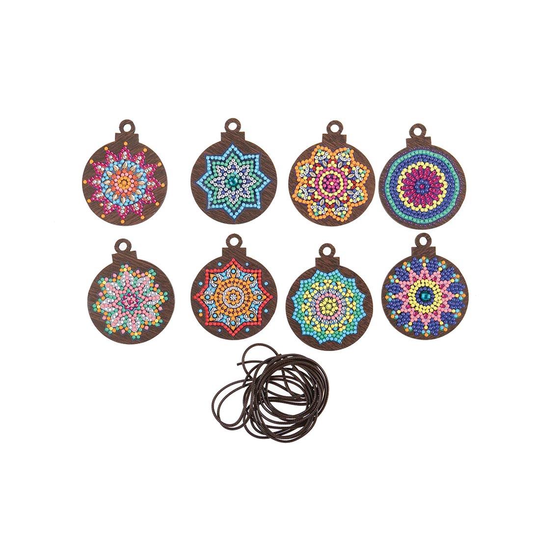 8 completed examples and hanging cord from the Crystal Art Mandala Mayhem Wooden Hanging Decoration Kit