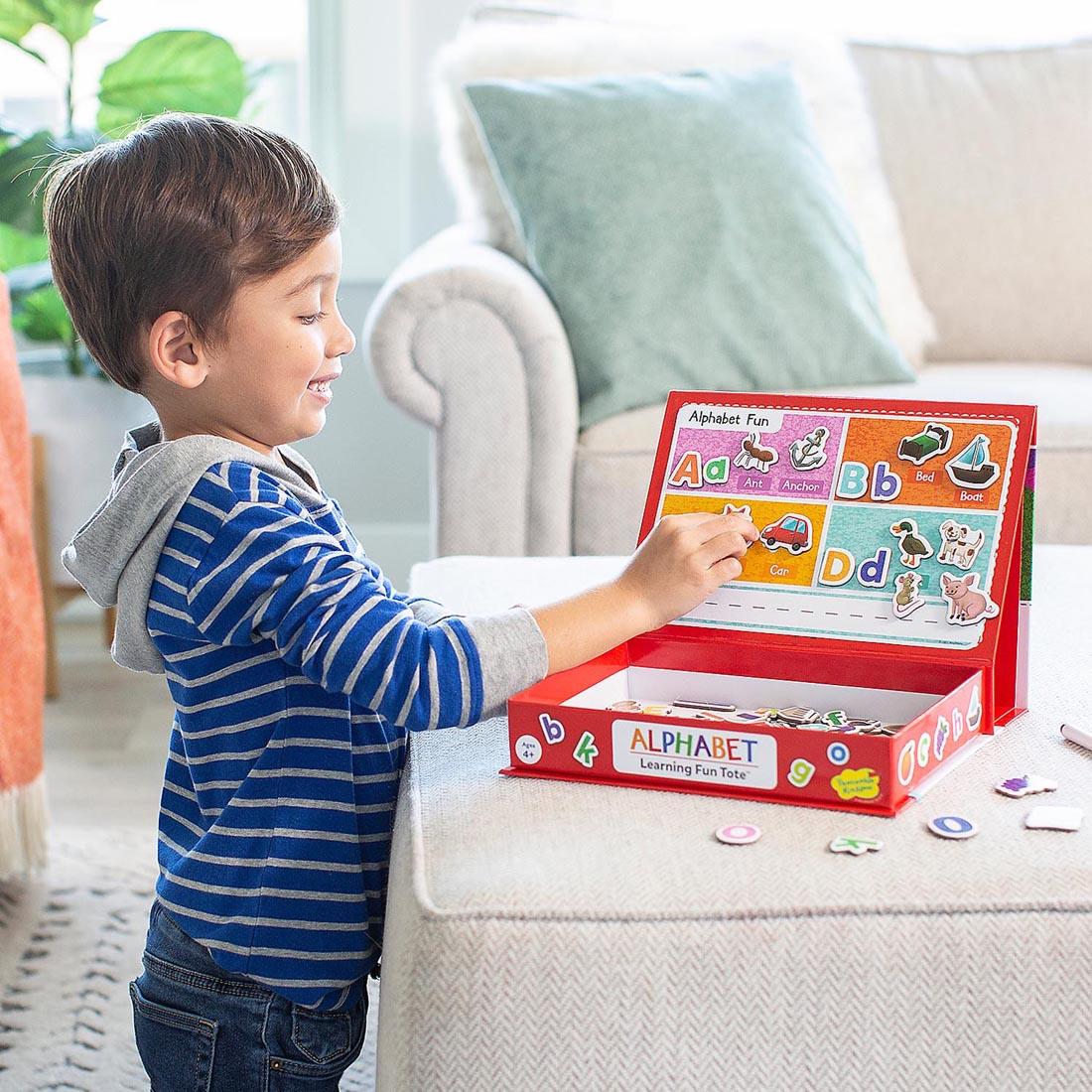 child playing with the Alphabet Learning Fun Tote By Peaceable Kingdom