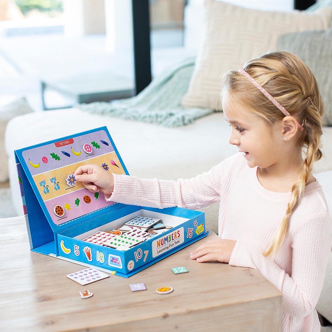 child playing with the Numbers Learning Fun Tote By Peaceable Kingdom