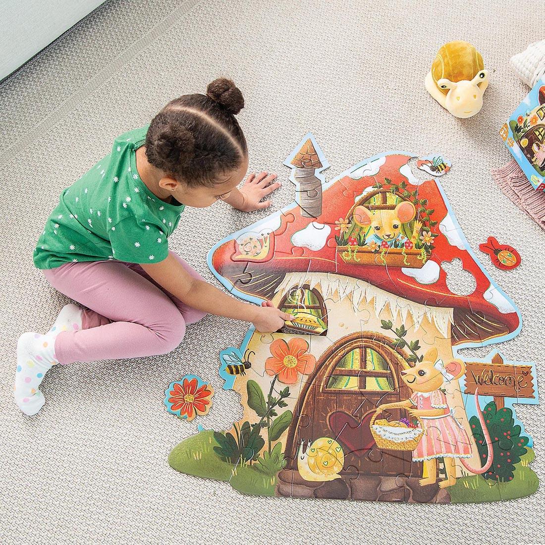 child completing the Mouse House Floor Puzzle By Peaceable Kingdom