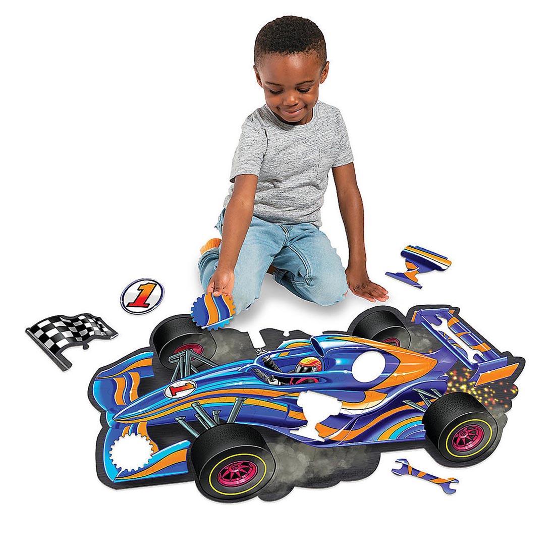 child completing the Racecar Floor Puzzle By Peaceable Kingdom