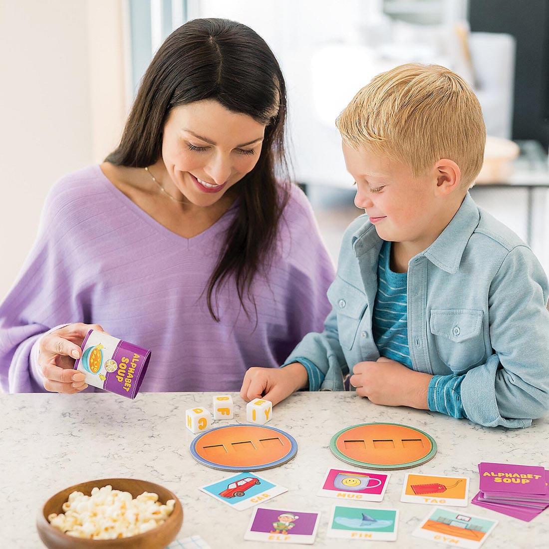child and adult playing the Alphabet Soup Spelling Game By Peaceable Kingdom