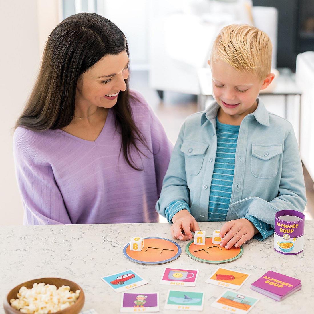 child and adult playing the Alphabet Soup Spelling Game By Peaceable Kingdom