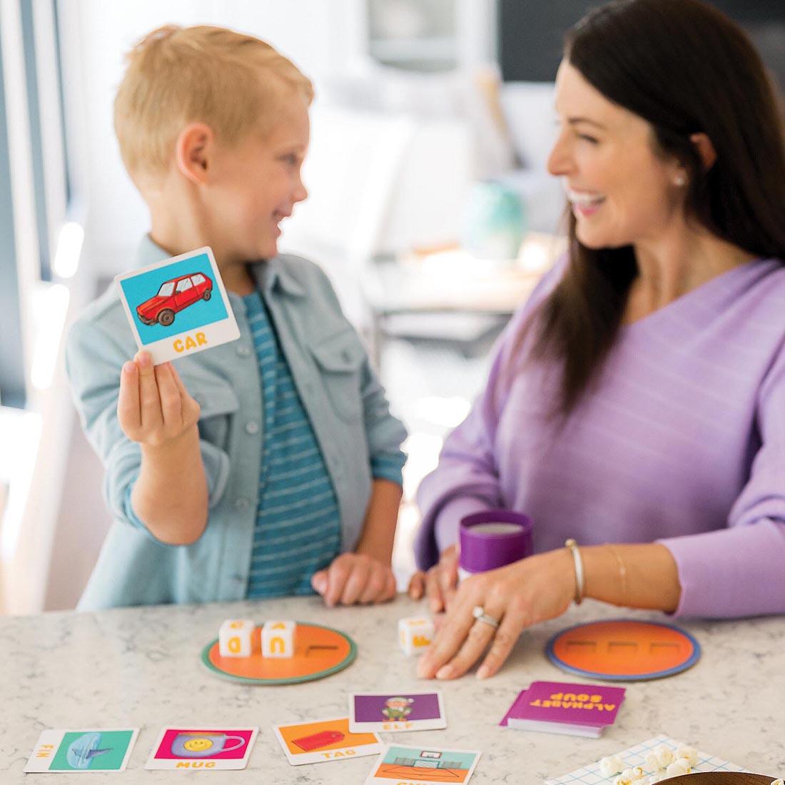 child and adult playing the Alphabet Soup Spelling Game By Peaceable Kingdom