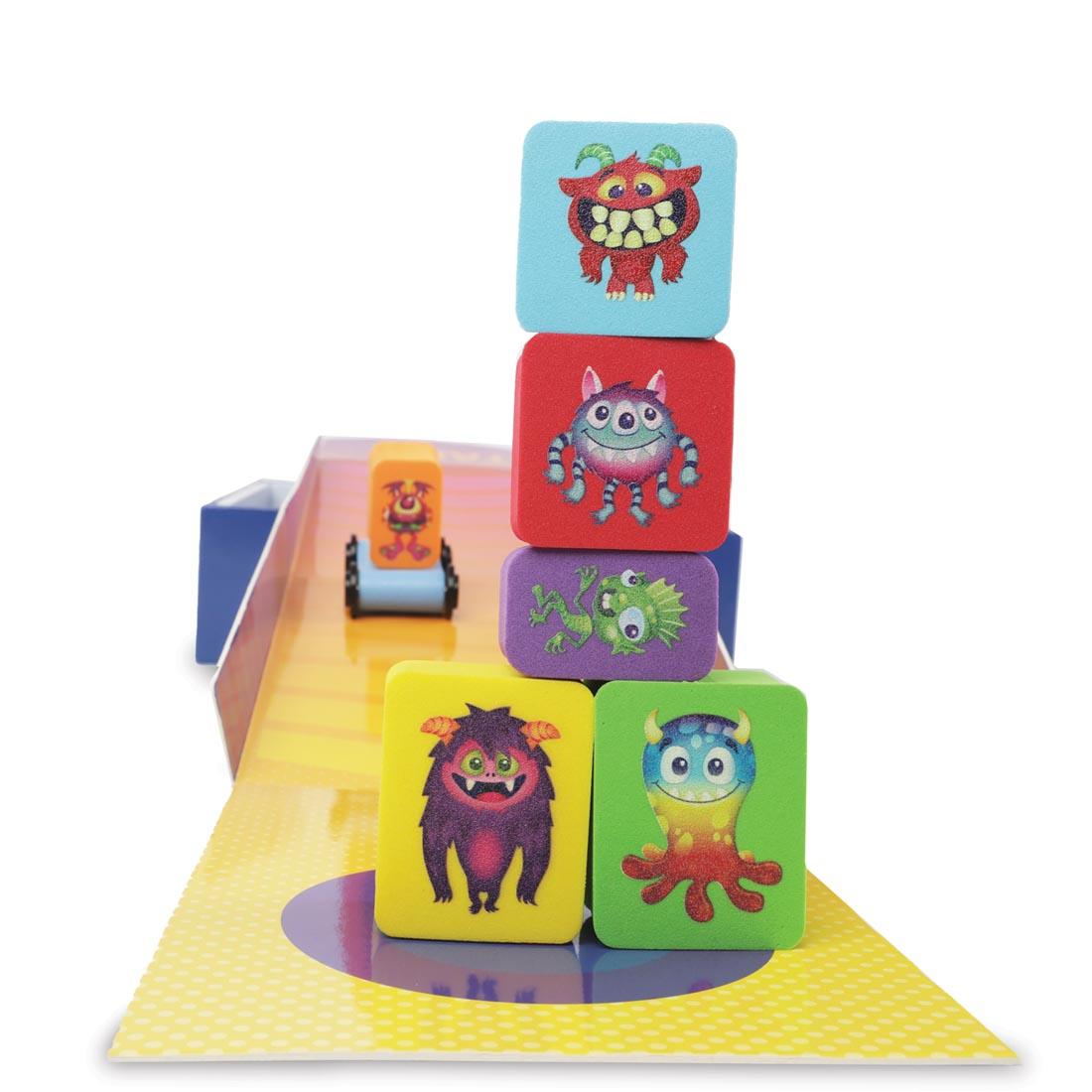 Foam monster blocks stacked on top of each other, with a monster on a skateboard in the background