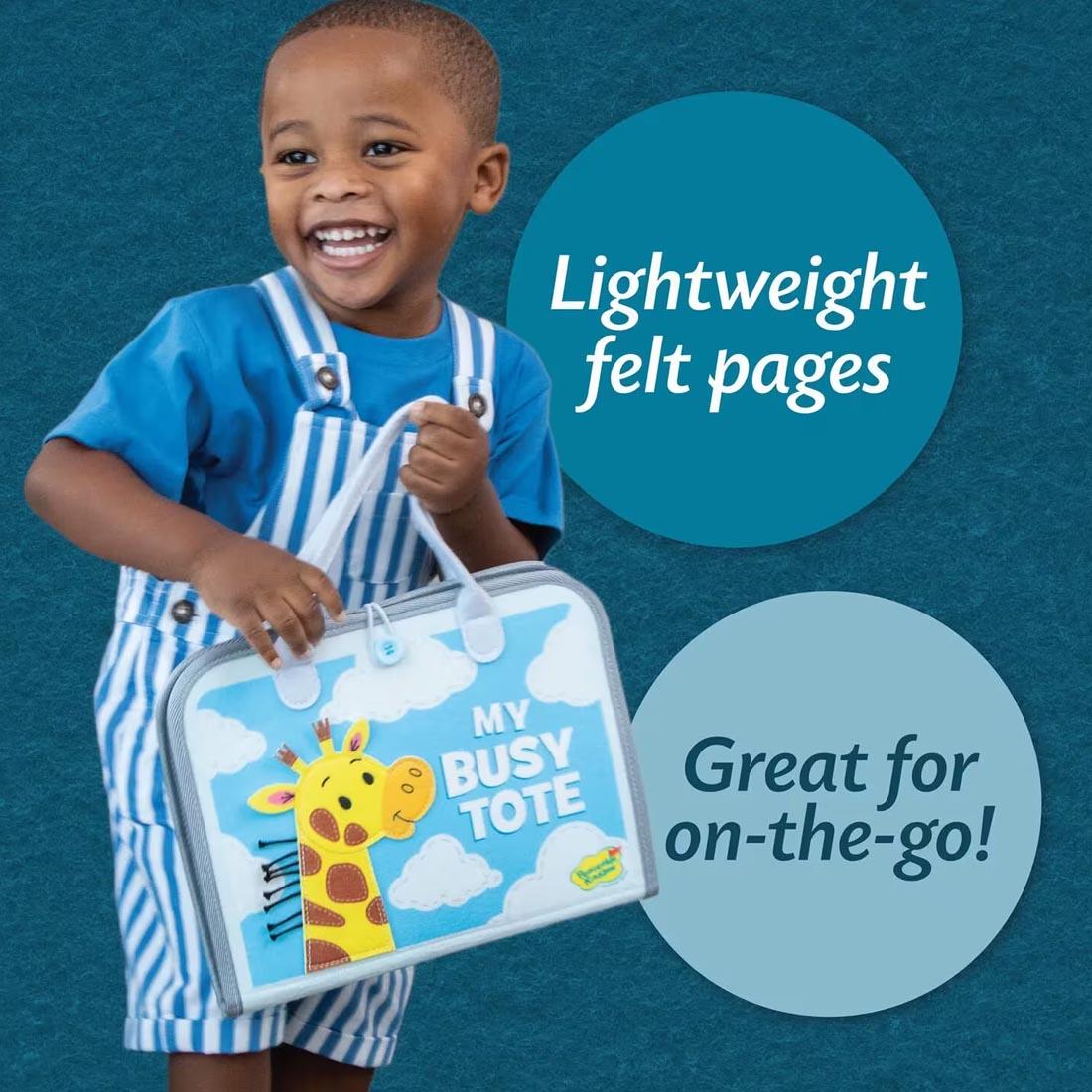 child holding My Busy Tote By Peaceable Kingdom plus text Lightweight felt pages; Great for on-the-go!