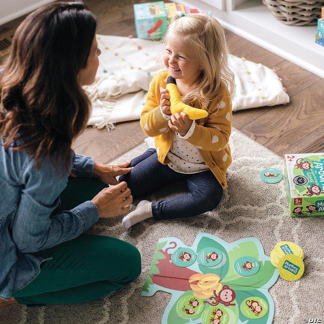 Adult and child playing the Monkey Around: The Wiggle And Giggle Game by Peaceable Kingdom