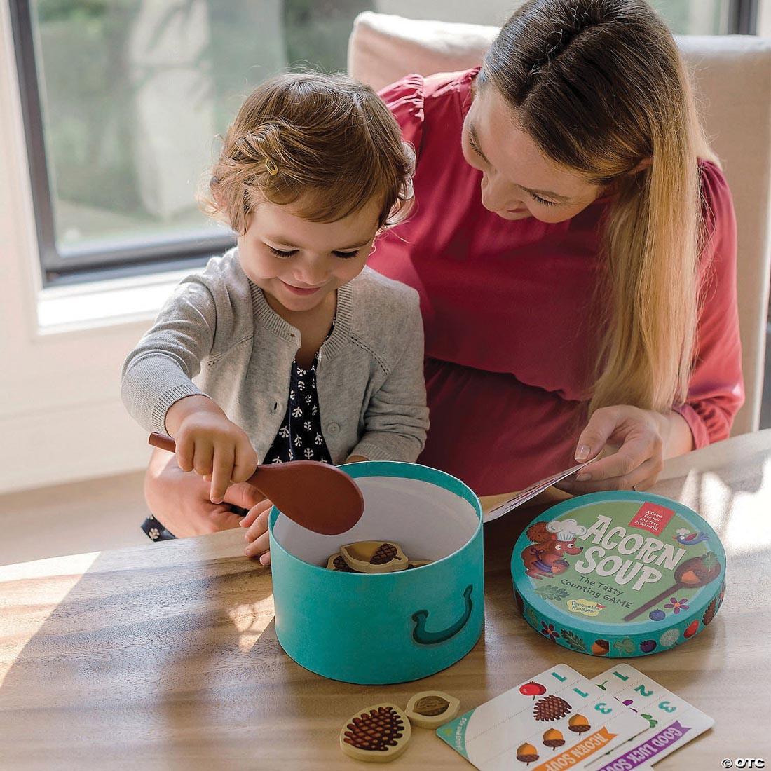 Adult and child playing the Acorn Soup Counting Game