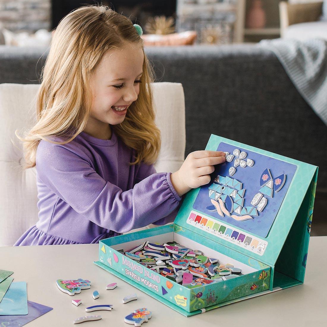 Child playing with Mermaid Island Sparkle Mosaics by Peaceable Kingdom