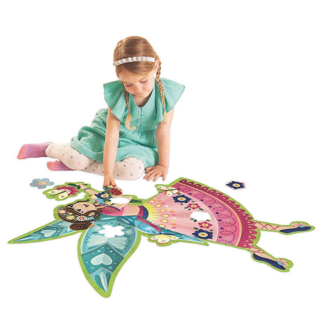 Child completing the Fairy Floor Puzzle by Peaceable Kingdom