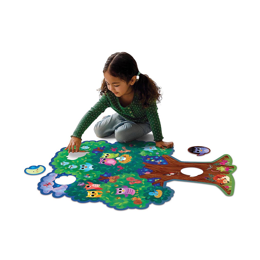 Child completing the Hoot Owl Hoot Floor Puzzle by Peaceable Kingdom