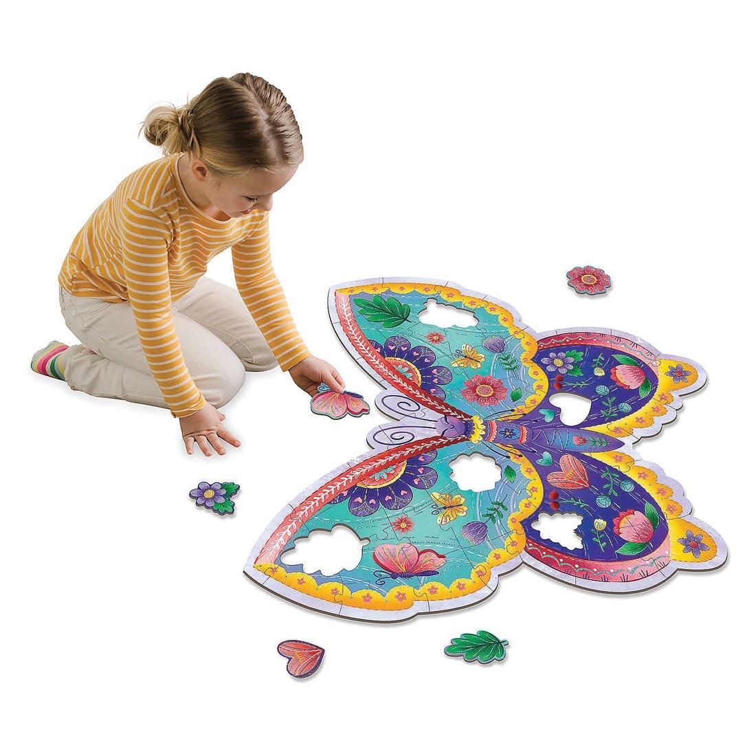 child completing the Butterfly Floor Puzzle By Peaceable Kingdom