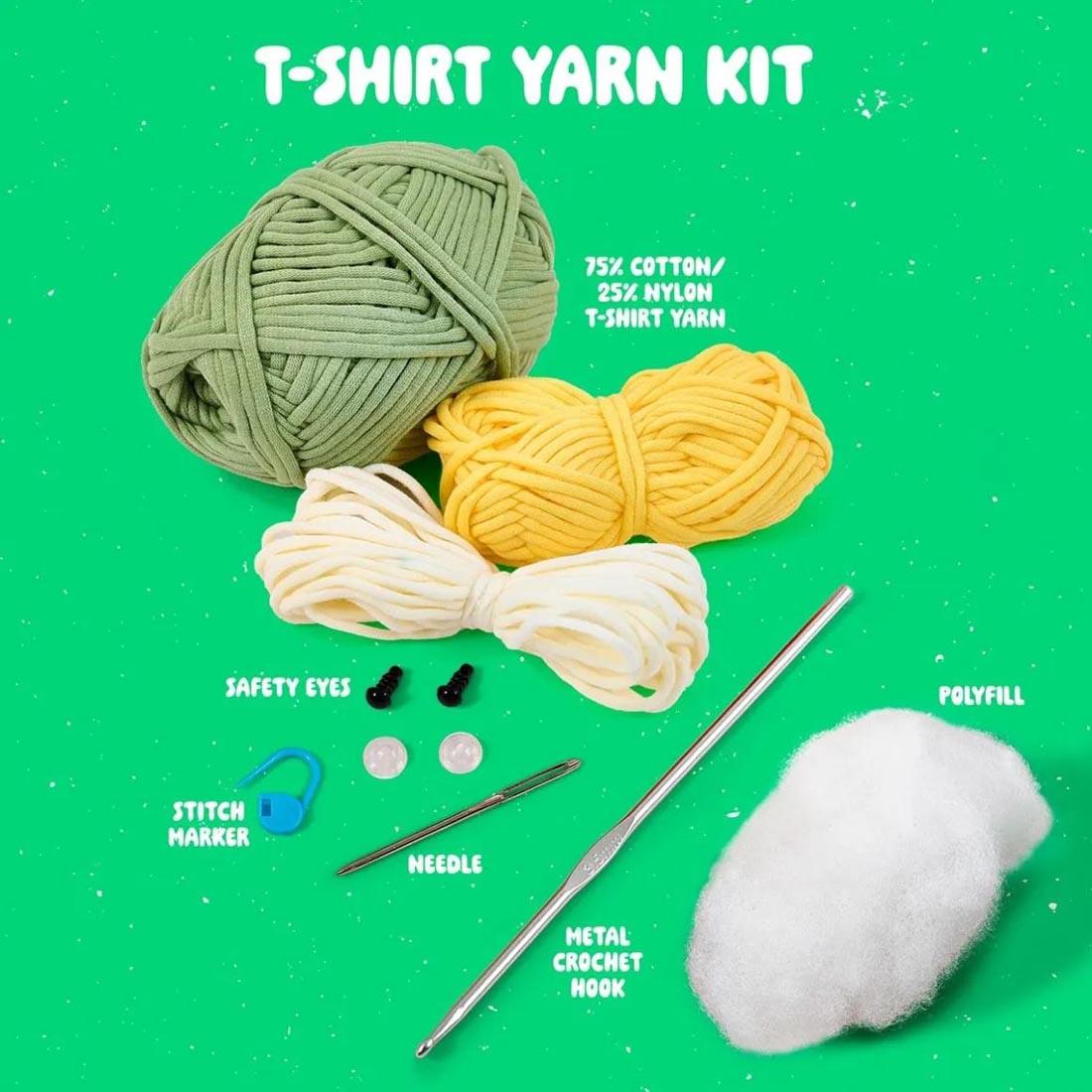 components of Dan The Dino Complete Crochet Kit labeled: T-Shirt Yarn Kit; 75% Cotton/25% Nylon T-Shirt Yarn; Safety Eyes; Stitch Marker; Needle; Metal Crochet Hook; Polyfill