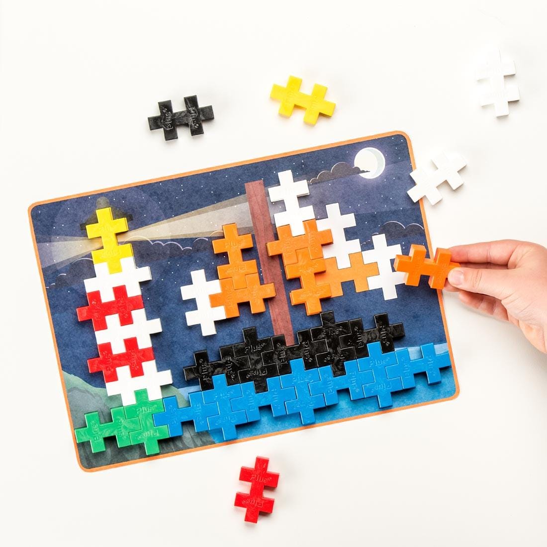 hand completing a Plus-Plus BIG 60-Piece Basic Picture Puzzle