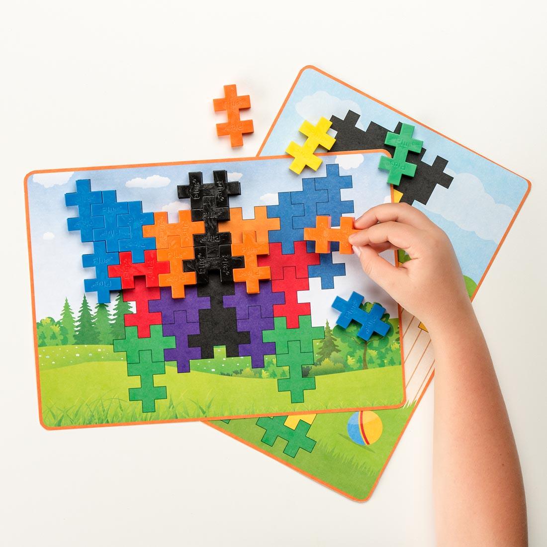 hand completing a sample Plus-Plus BIG 60-Piece Basic Picture Puzzle