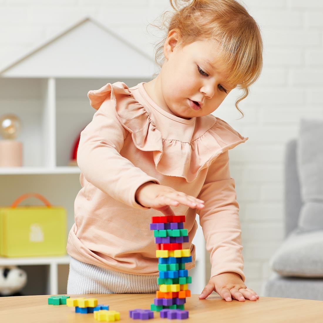 child playing with pieces from the Plus-Plus BIG Learn To Build Activity Set