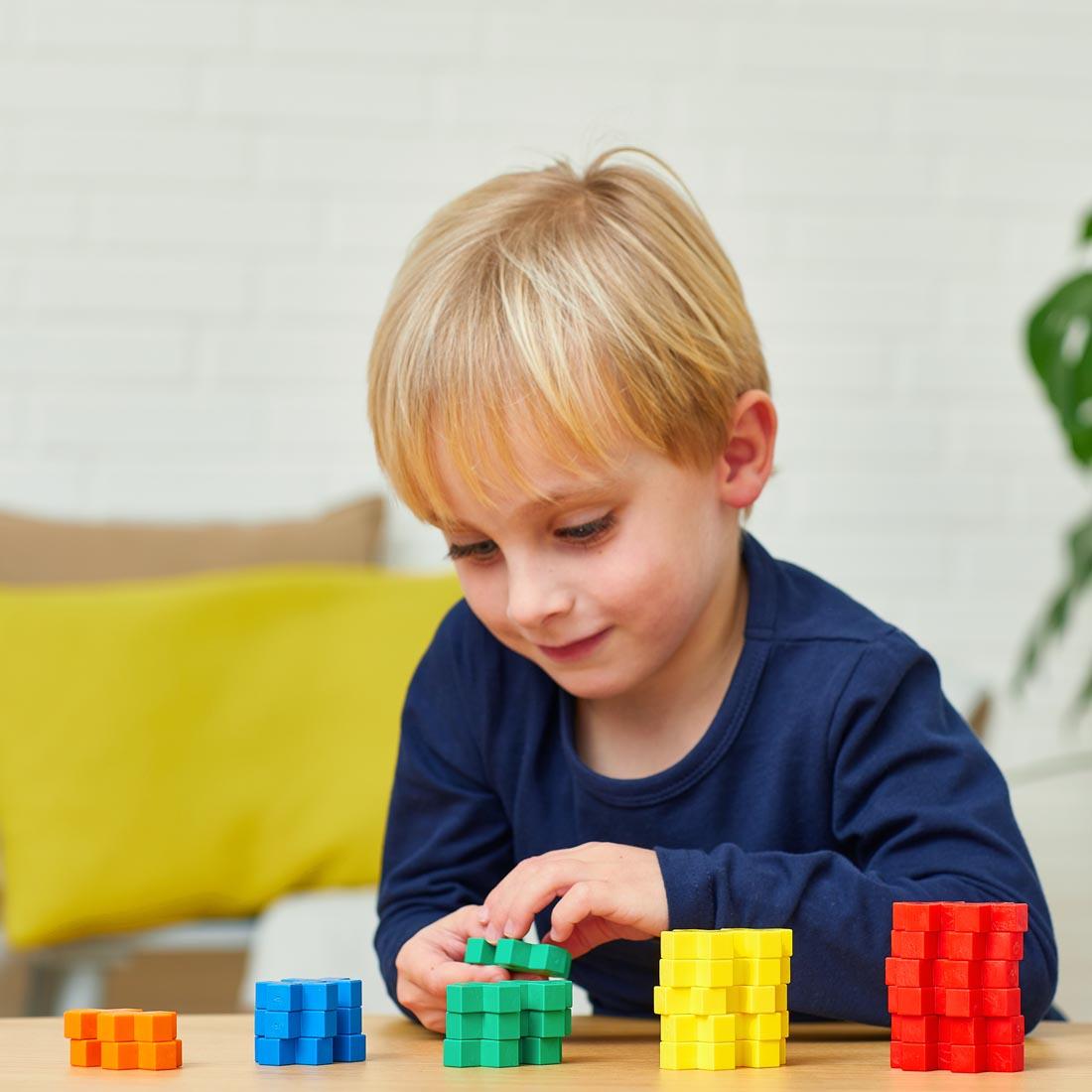child playing with pieces from the Plus-Plus BIG Learn To Build Activity Set