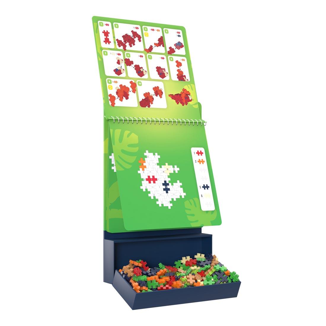 Plus-Plus Puzzle By Number Dinosaur Activity Pad with drawer open and a page flipped up