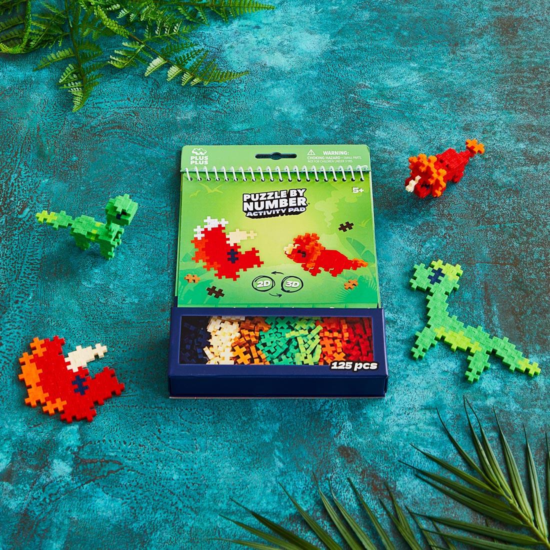 Plus-Plus Puzzle By Number Dinosaur Activity Pad plus some example completed creations