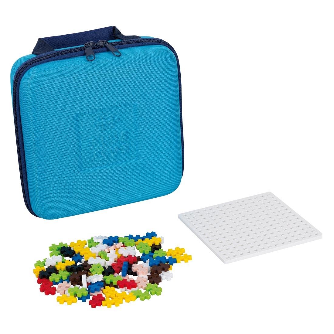 Plus-Plus Travel Case beside a base plate and Plus-Plus pieces