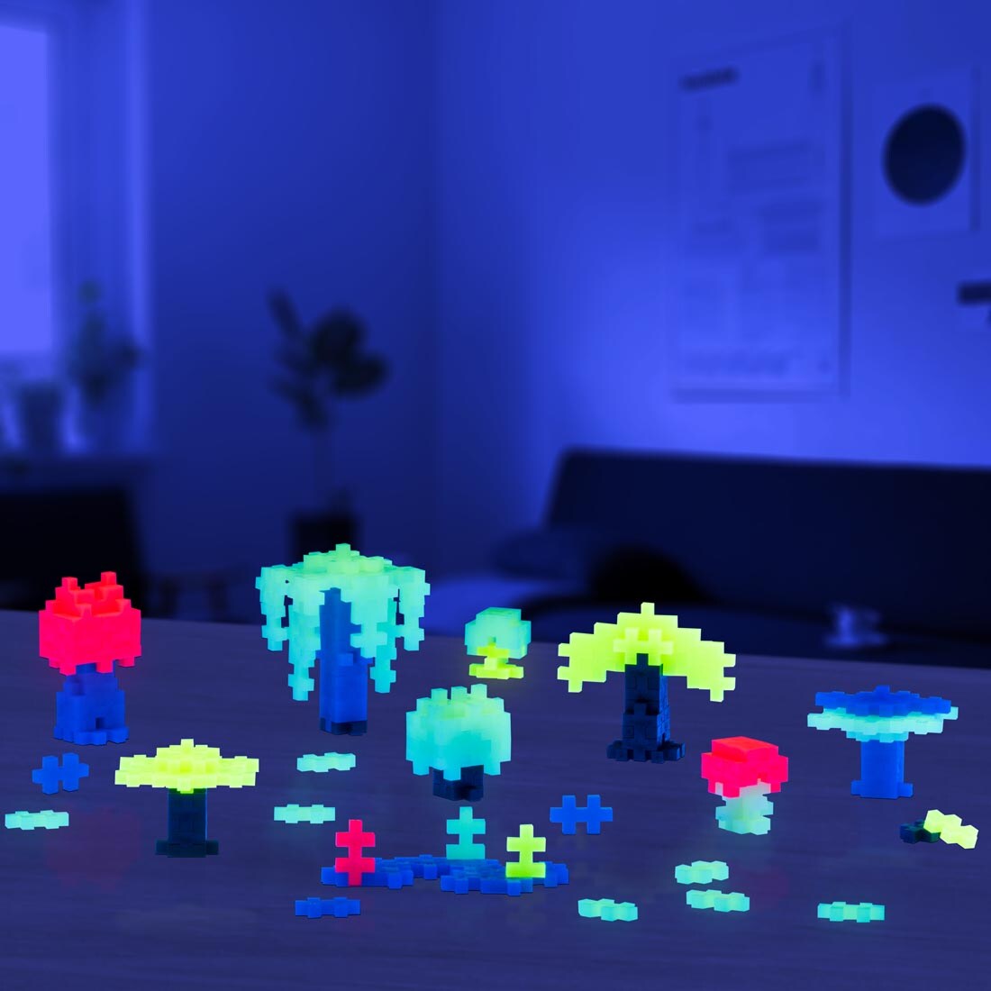 sample creations made with the Plus-Plus 70-Piece Glow Mix Tube shown glowing in the dark