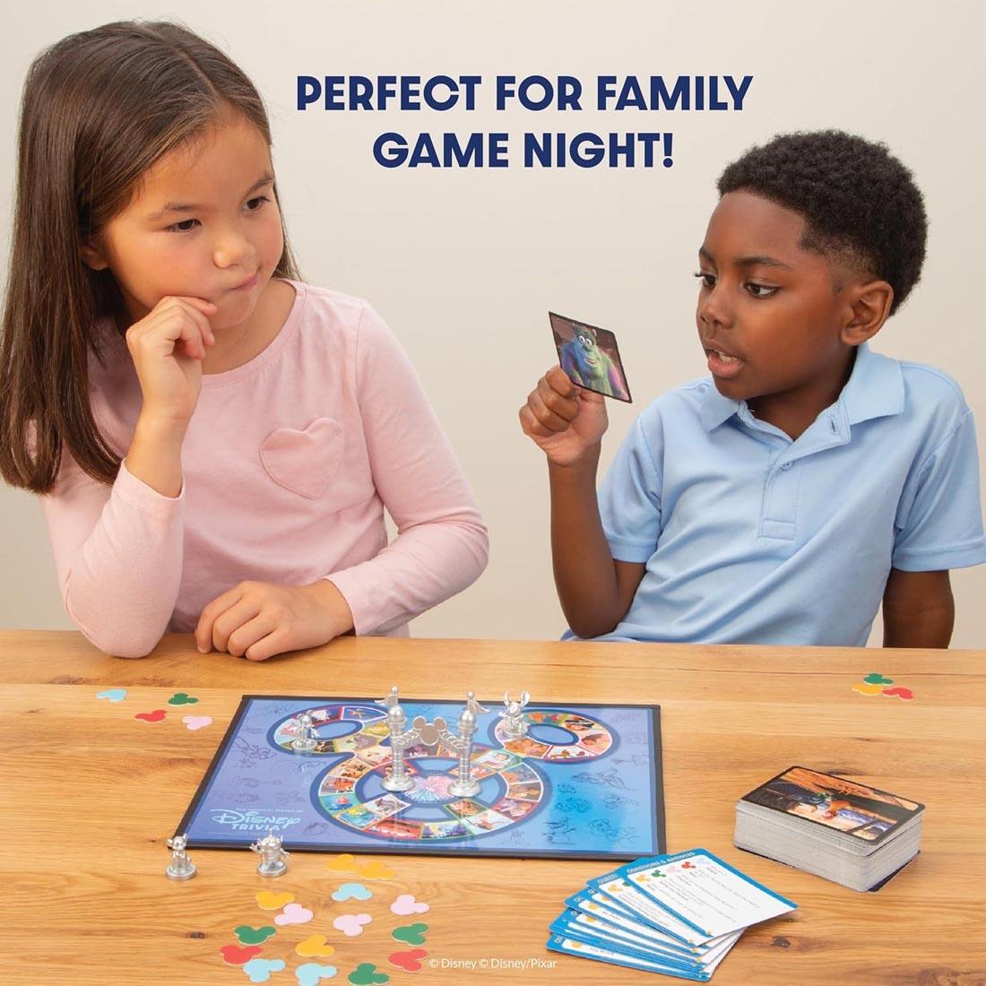 2 kids playing The Magical World Of Disney Trivia Kids Edition Game plus text perfect for family game night!