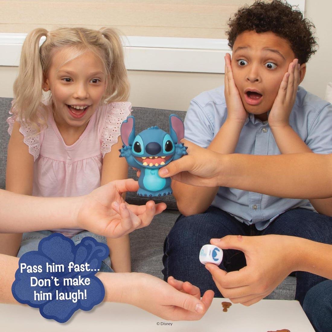 kids playing the Laughing Stitch Game plus text Press him fast..don't make him laugh!