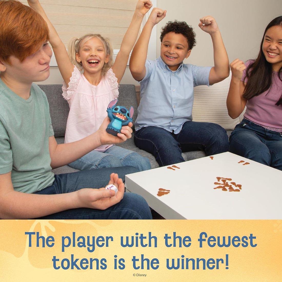 kids playing the Laughing Stitch Game plus text The player with the fewest tokens is the winner!