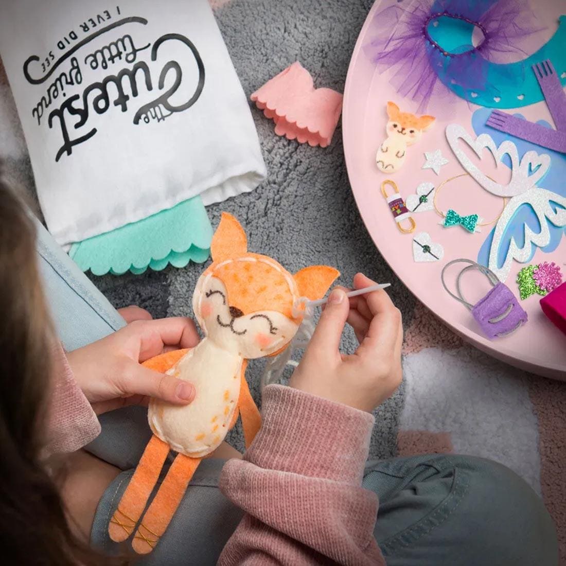 hands sewing a stuffed fox from the Craft-Tastic Make A Fox Friend Kit