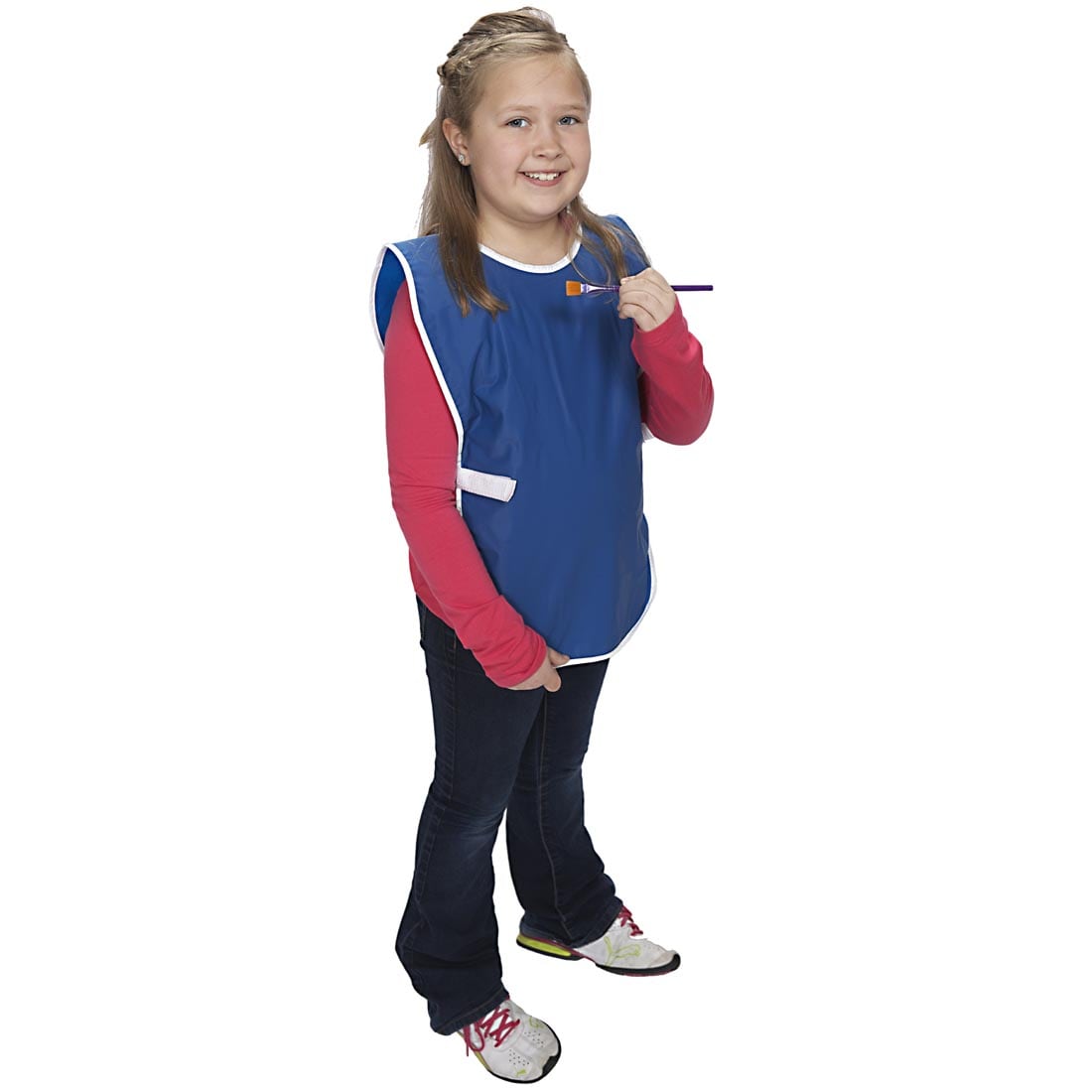 Child holding a paintbrush wearing the Sleeveless KinderSmock