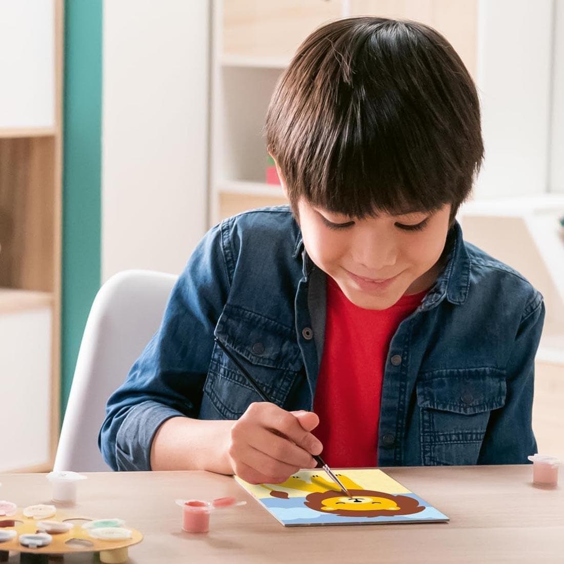 child using the Wild Lion Kids Paint By Number Set By Ravensburger