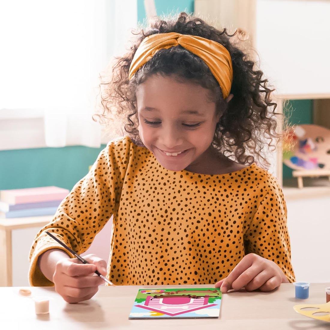 child using the Dachshund Kids Paint By Number Set By Ravensburger