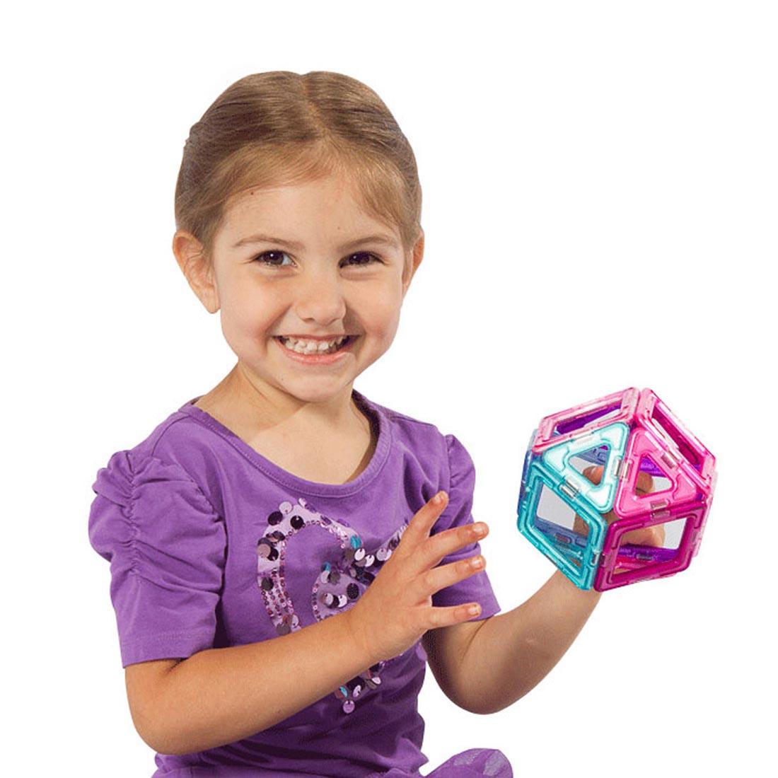 Child holding a sphere made of pieces from the Magformers 14-Piece Inspire Set