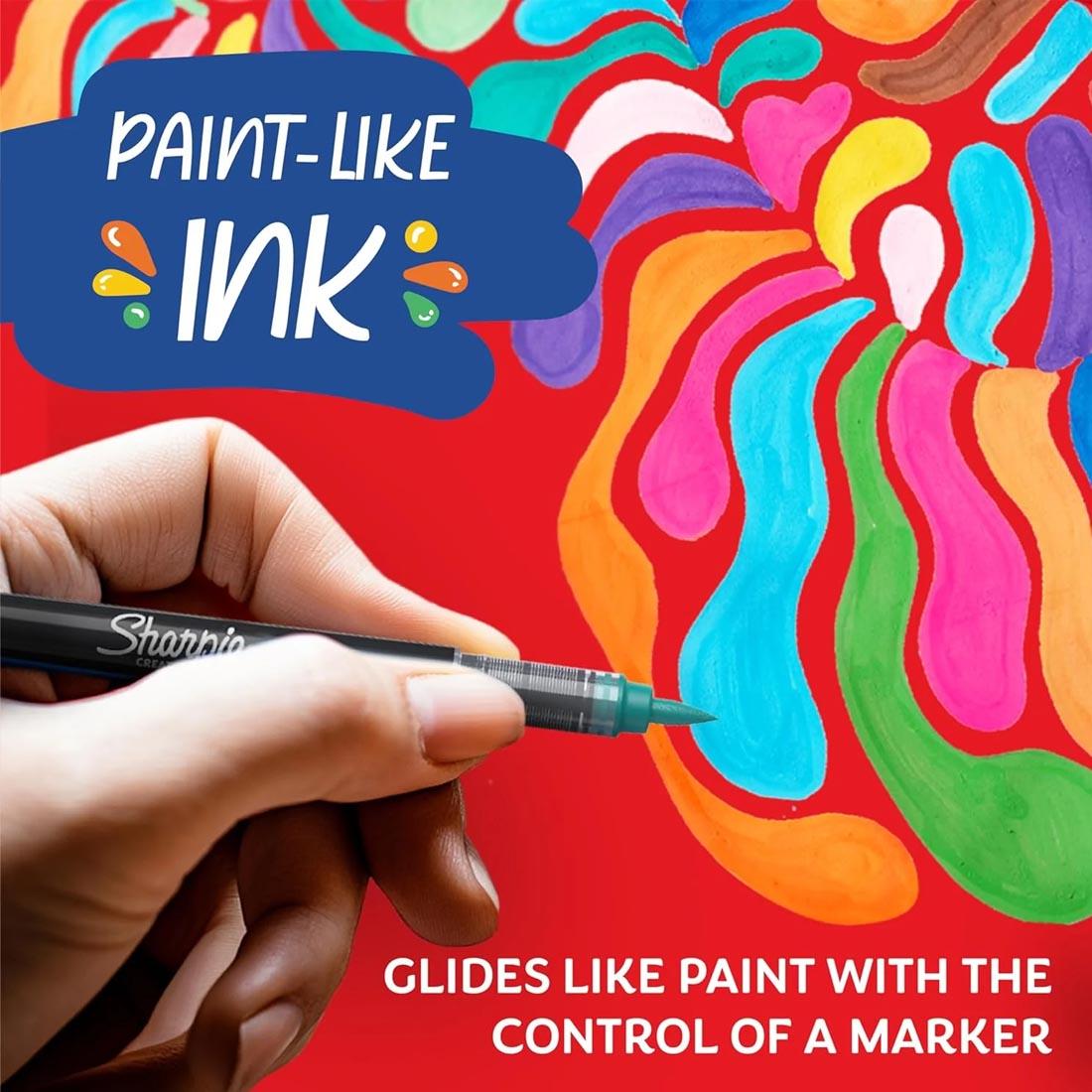 hand holding a Sharpie Creative Brush Tip Marker and text Paint-Like Ink; Glides like paint with the control of a marker