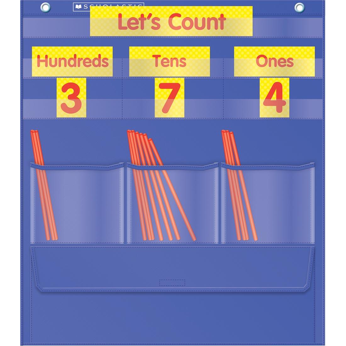 Counting Caddie and Place Value Pocket Chart shown in use with the included straws and the Let's Count header