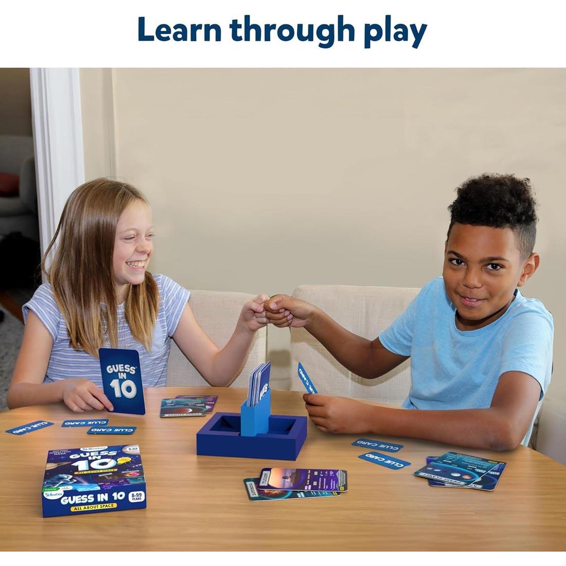 2 children playing Guess In 10 Space Game By Skillmatics with text: Learn through play
