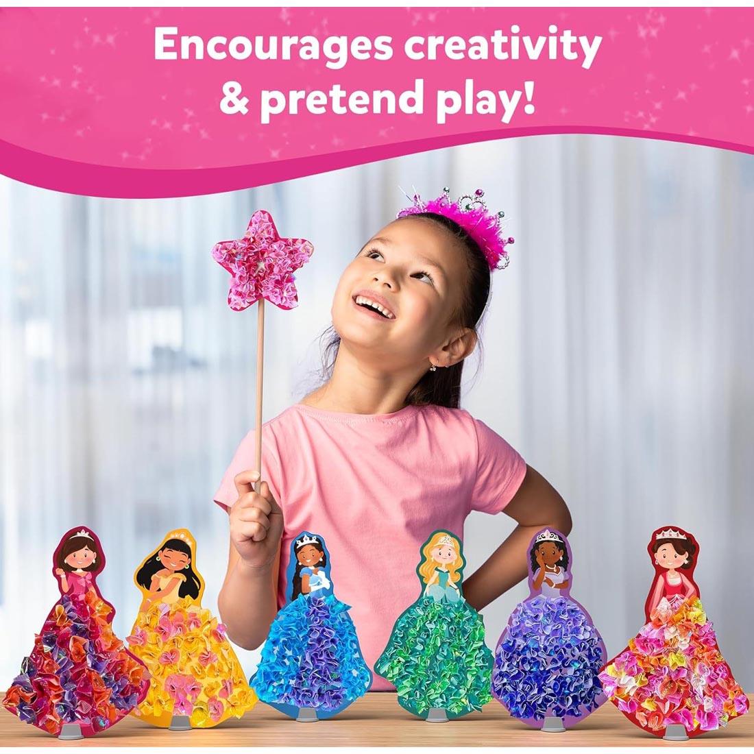child standing behind 6 completed princesses and holding the star from Poke-In Art Magical Princesses Craft Kit with text: Encourages creativity & pretend play!