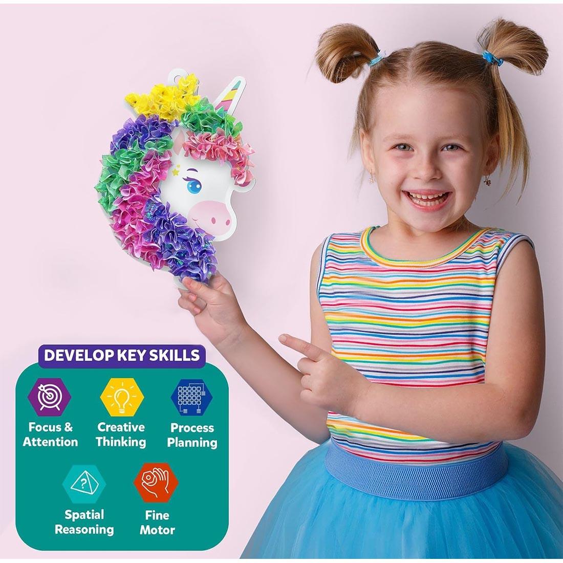 girl showing a completed poke-in art project, with benefits listed: focus & attention; creative thinking; process planning; spatial reasoning; and fine motor