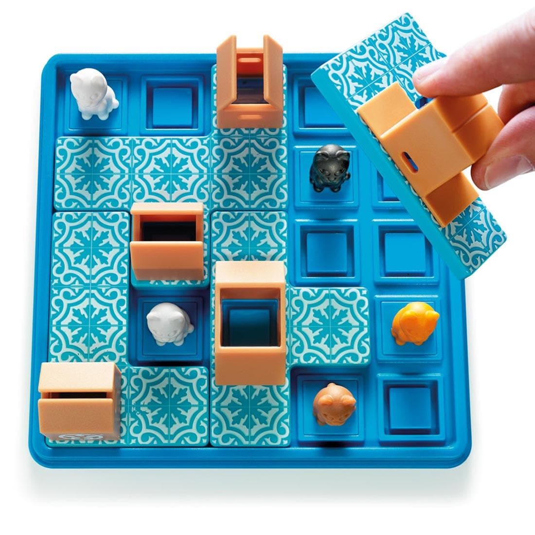 hand holding a piece hovering over the Cats & Boxes Game by Smart Games